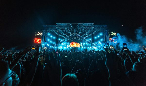 A festival main stage with blue stage lighting