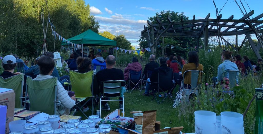 A photo of people sat outside for one of Nest Collectives Campfire Clubs.