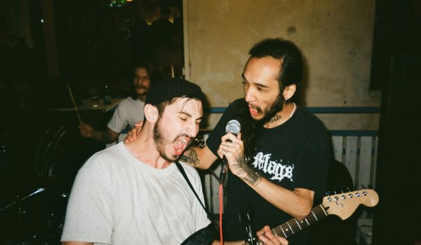 Two performers singing at a mic.