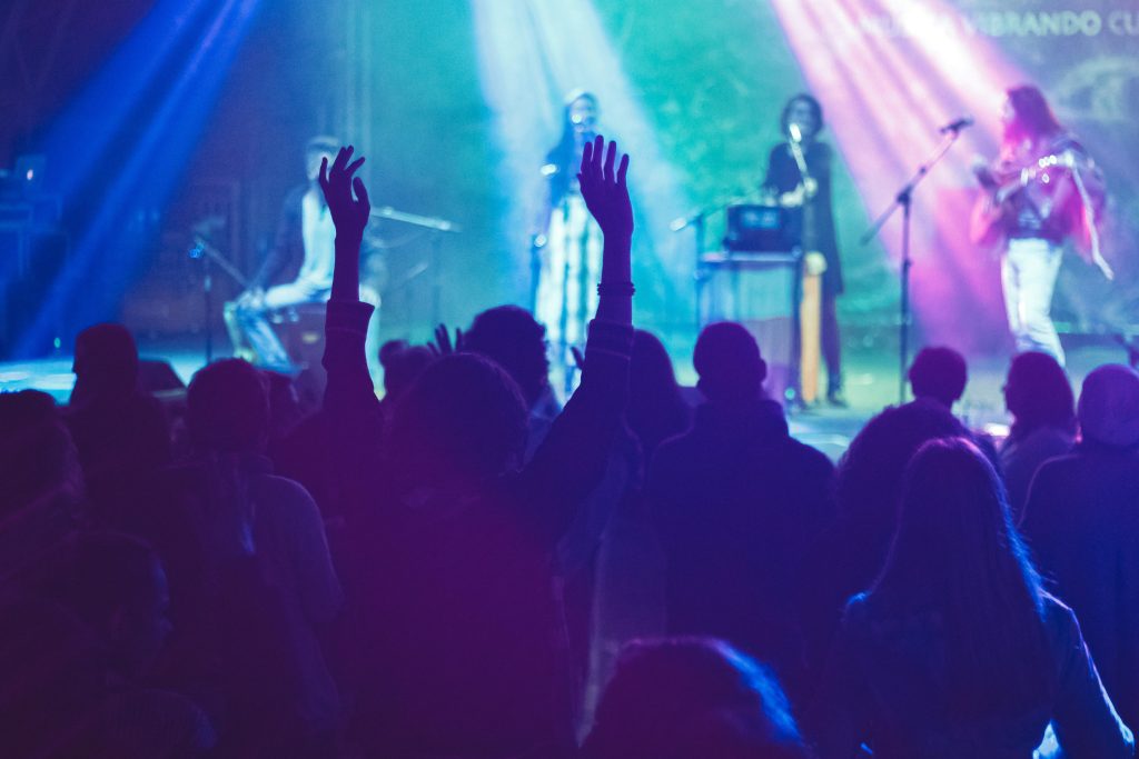 A crowd photograph featuring people with their arms outstretched.